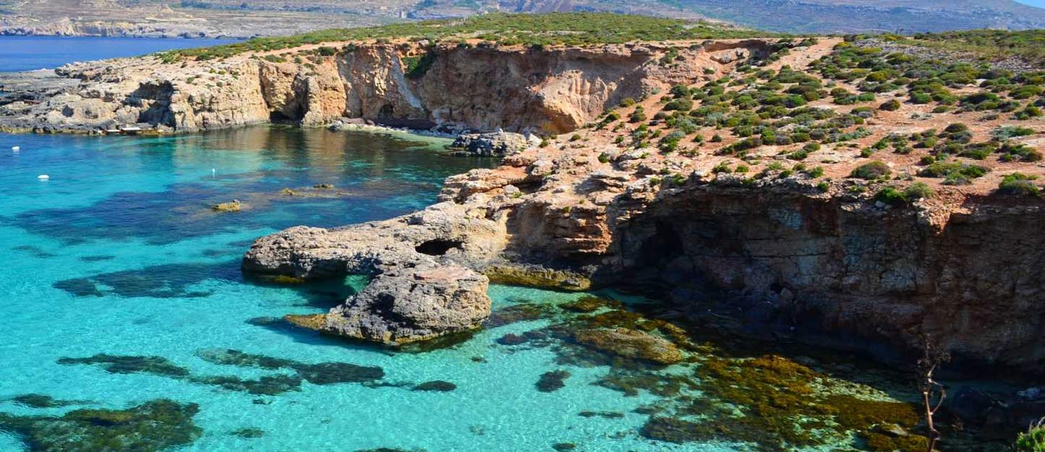 Turquoise water and limestone cliffs at the Blue Lagoon, Comino, Malta